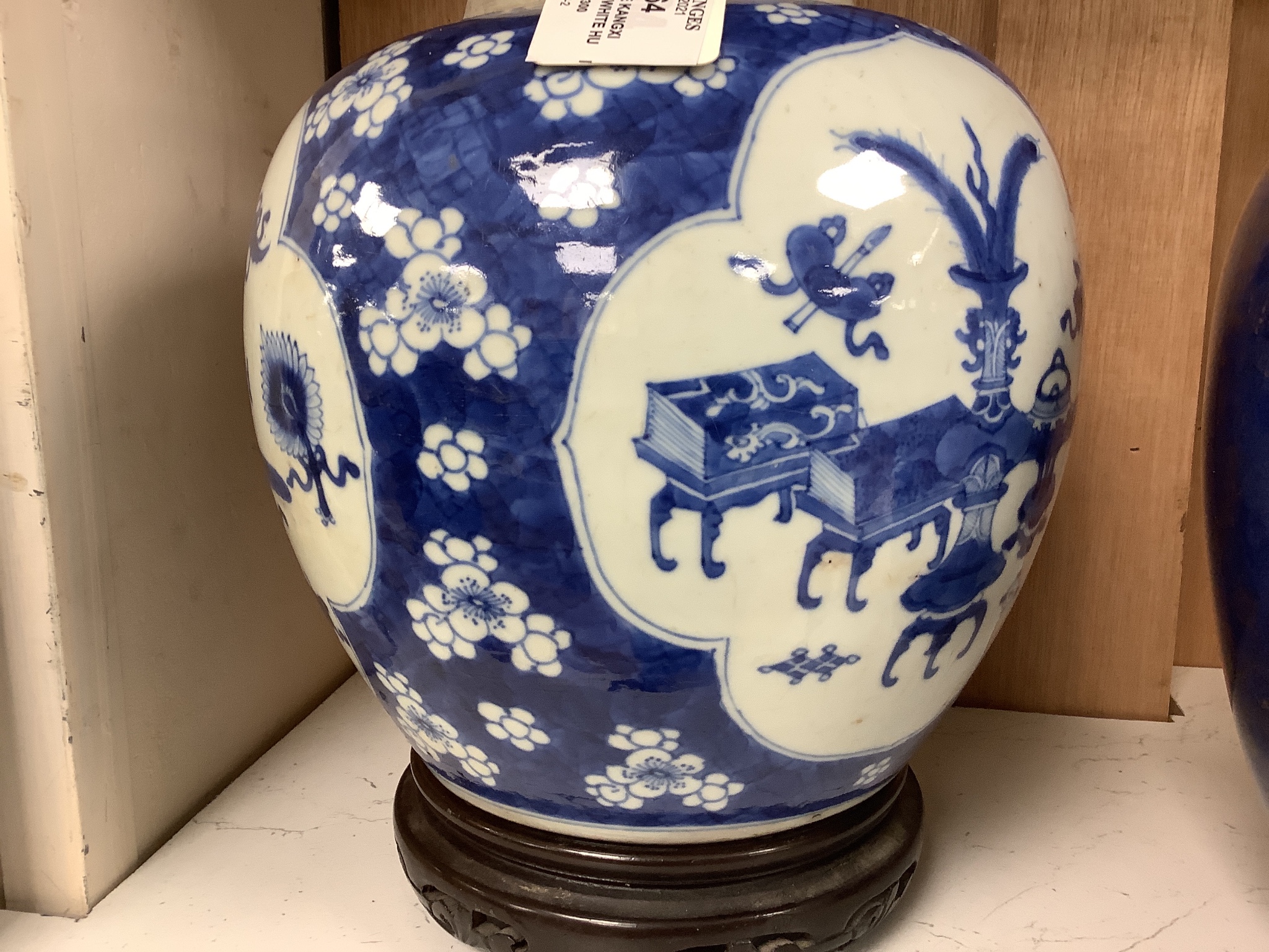 A Chinese Kangxi blue and white hundred antiques jar, 21cm, cracked, with hardwood stand and a Samson powder blue jar, 26cm, wear